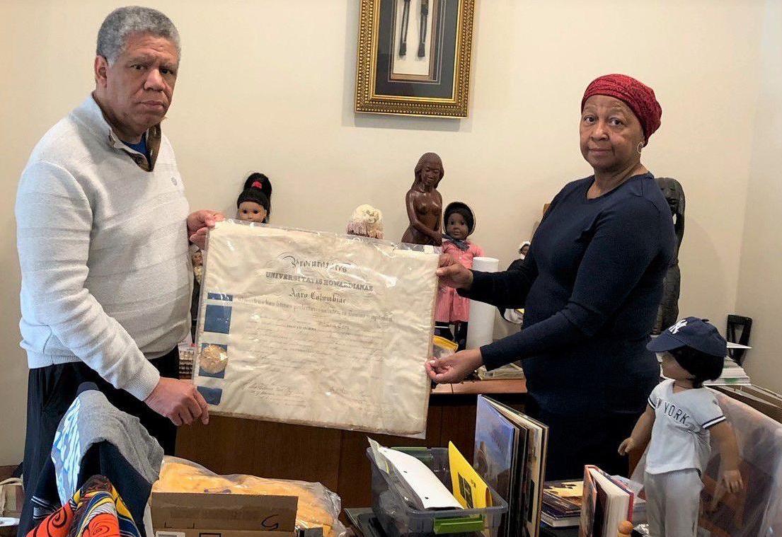 Melva and DeWitte Shipley with college diploma of family member William Troy and other items from Maris Grove's Black History Month exhibit.