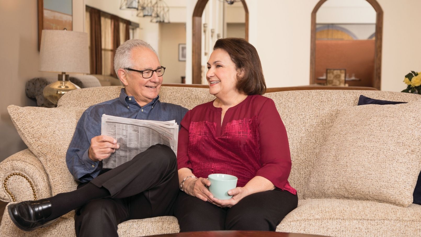 Two residents of Eagle's Trace seated in their stylish apartment home.