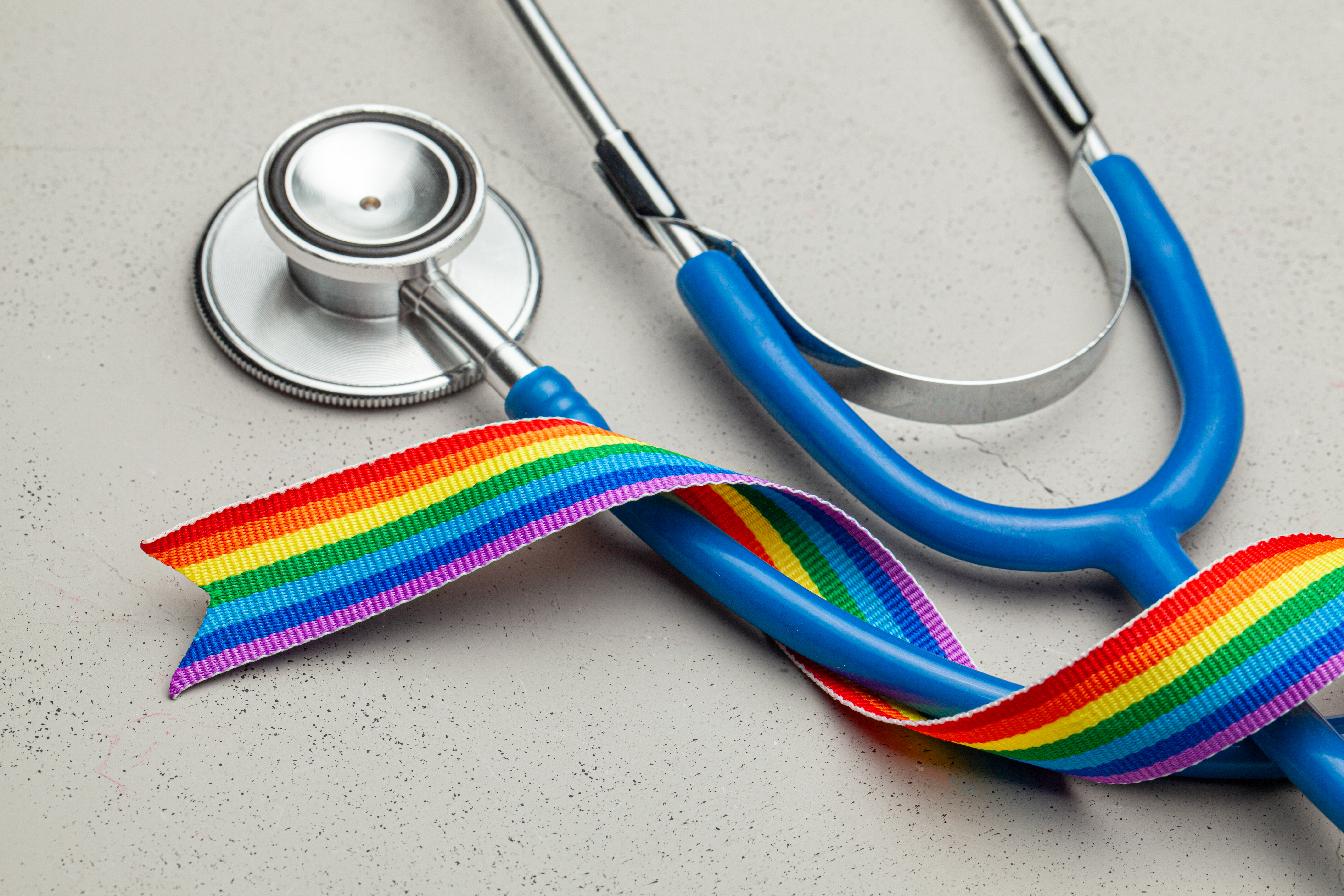 LGBT_Health Photo features a stethoscope and a rainbow ribbon