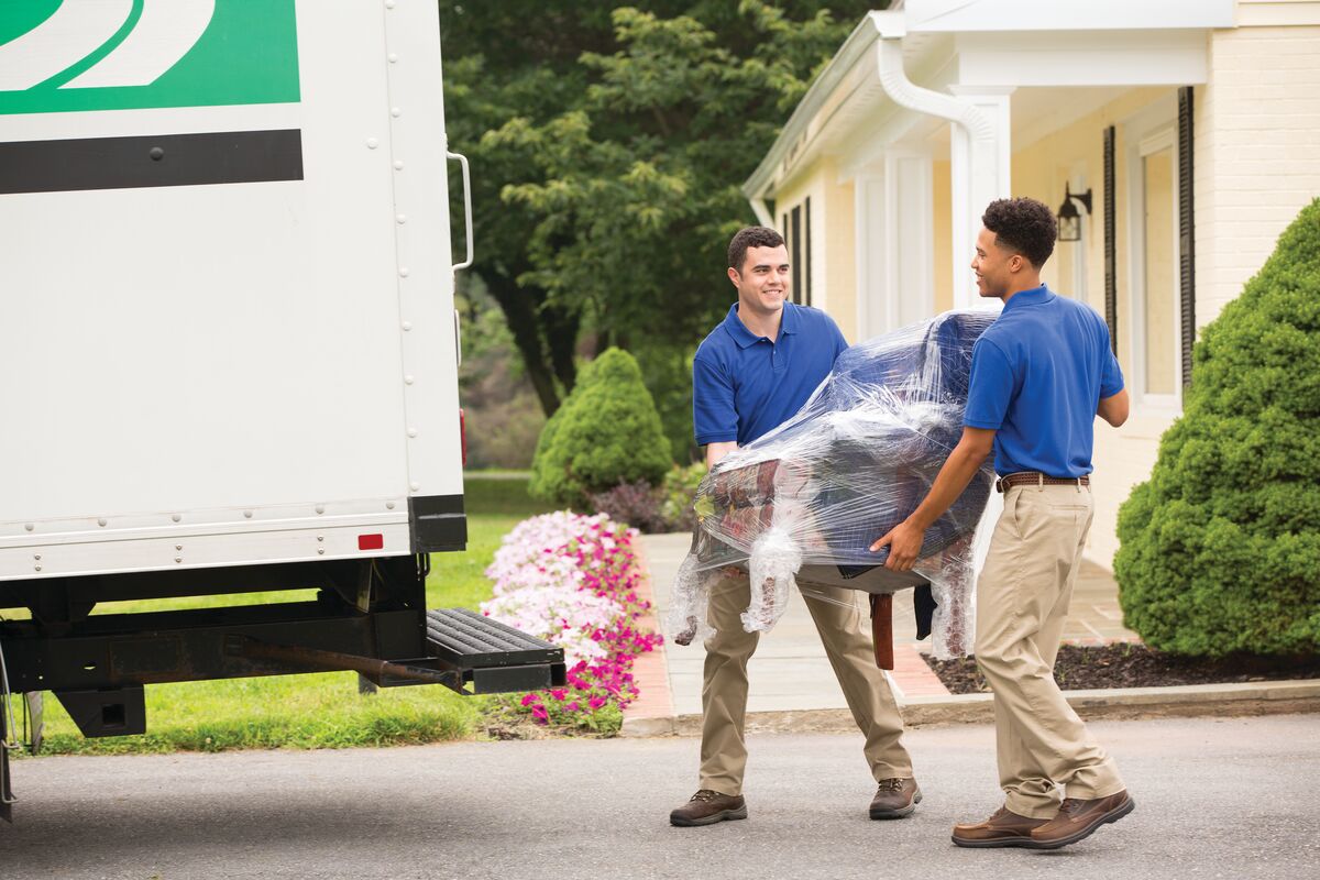 Medium-ERMS_7-2015_0122_CM.jpg1200x800 Two young men move a box into the back of a moving truck