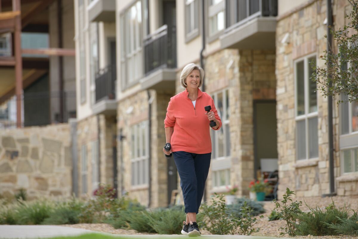 well-being Senior woman walks with weights
