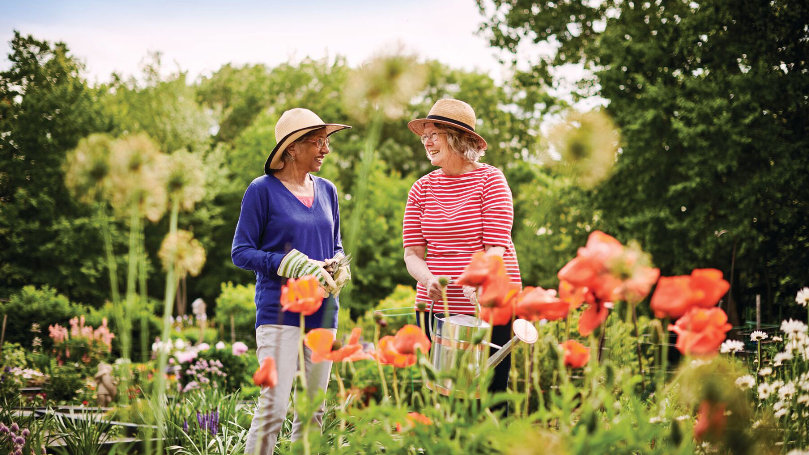 Two residents talking and laughing in the community garden.