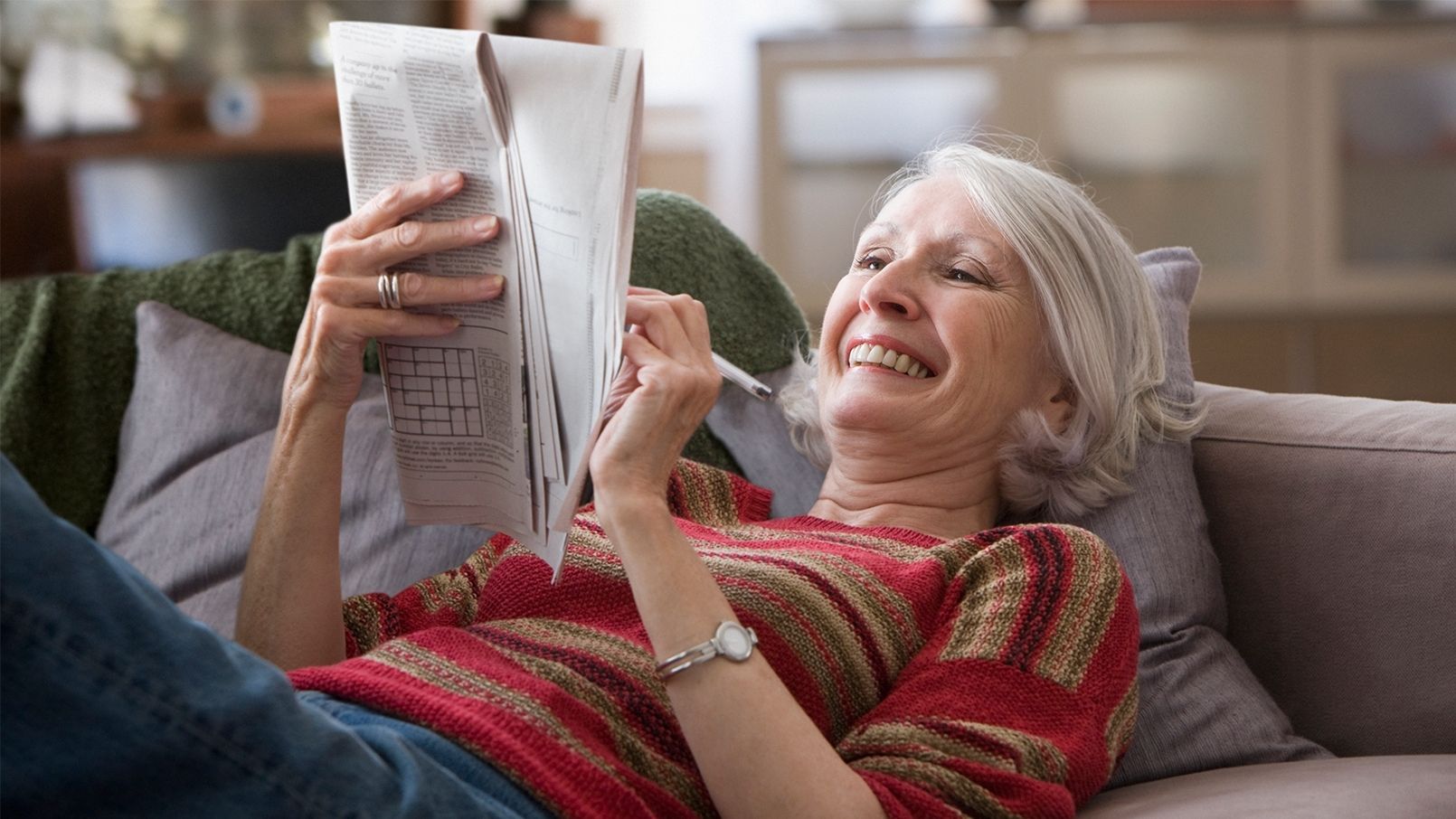 Woman relaxing with newspaper Woman relaxing