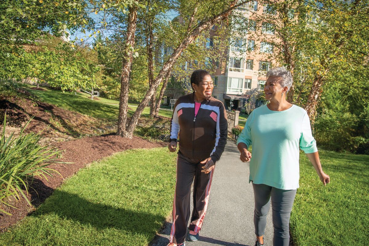 Senior living residents walking on a path