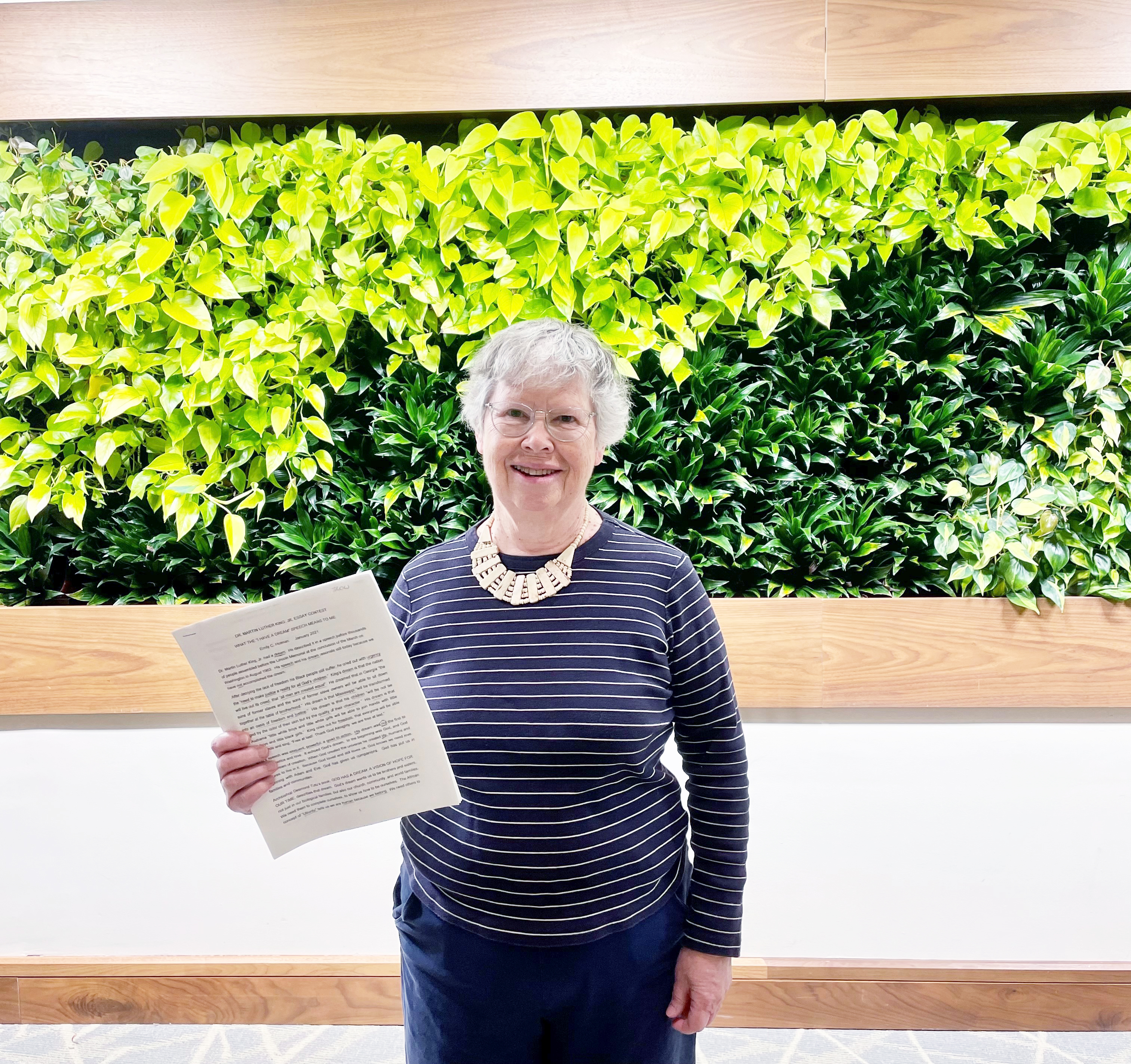 Senior living resident, Emily Holman holds her essay about the "I have a dream" speech