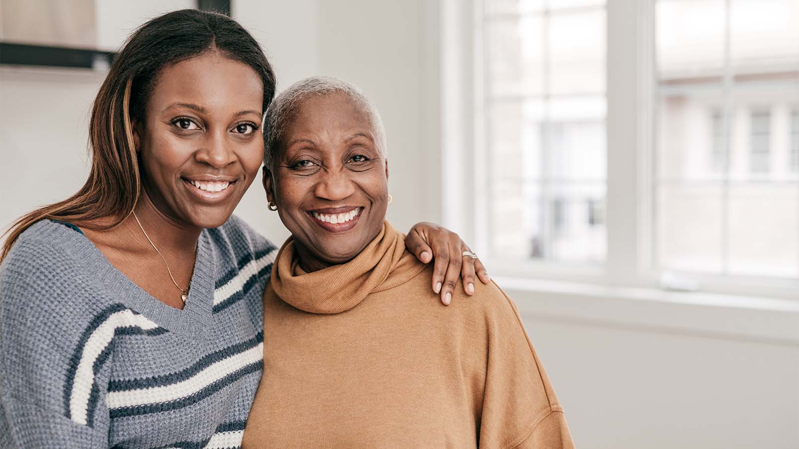 GettyImages-1297274356_1610x906 mother with adult child, smiling