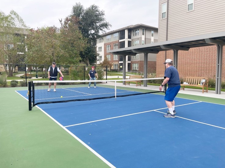 Residents at Eagle's Trace in West Houston enjoy playing pickleball on their outdoor court.