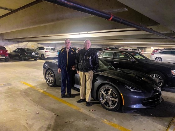 Residents of Fox Run pose with their car in the underground parking garage.