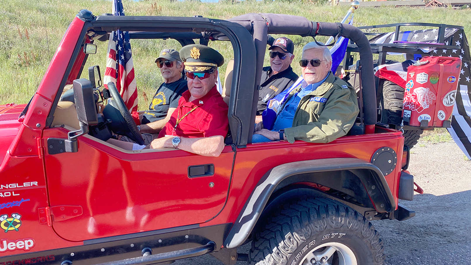 Wind Crest residents in a patriotic Jeep