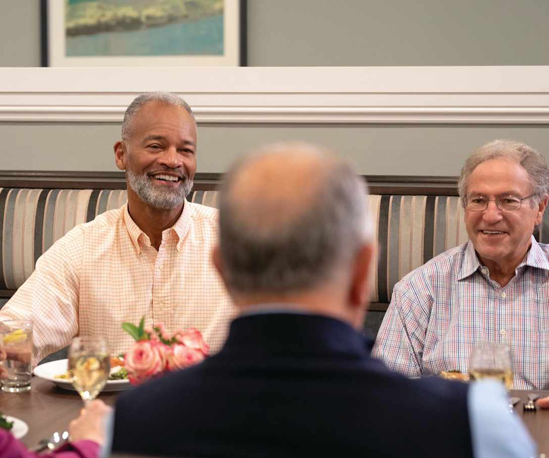Community residents enjoying conversation while dining at community restaurant