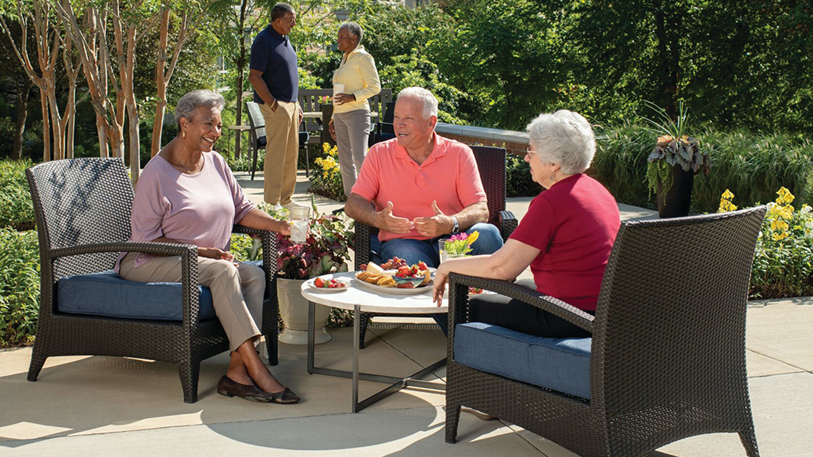 friends sitting at outdoor table and chairs