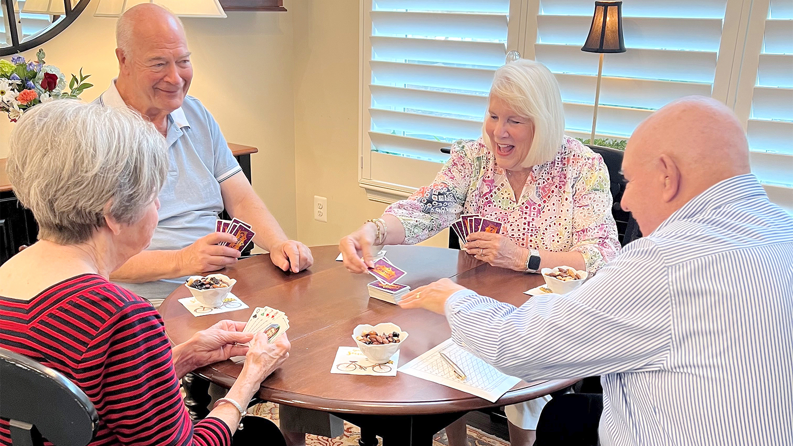 residents gathered at a table playing a game