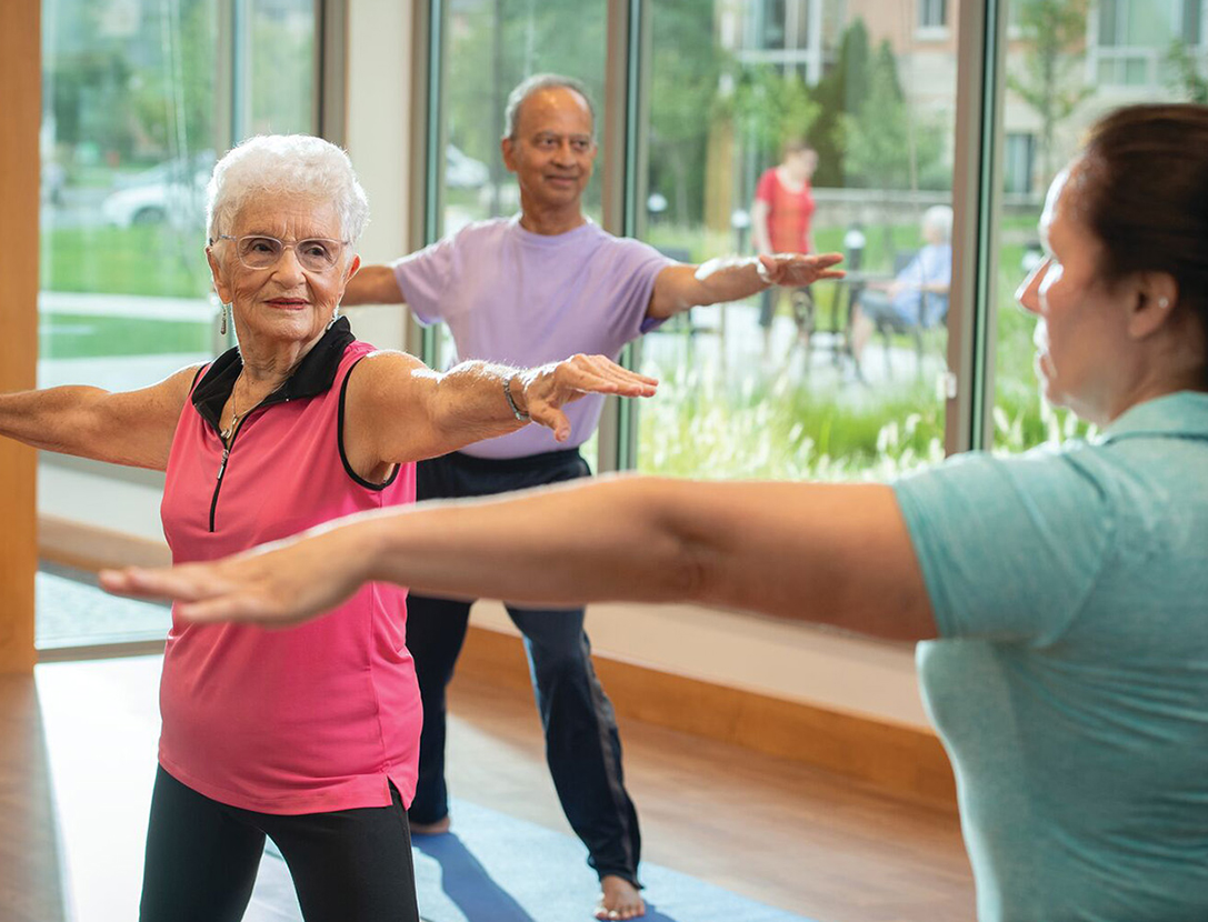 Active seniors participating in a studio fitness class at our vibrant living community.