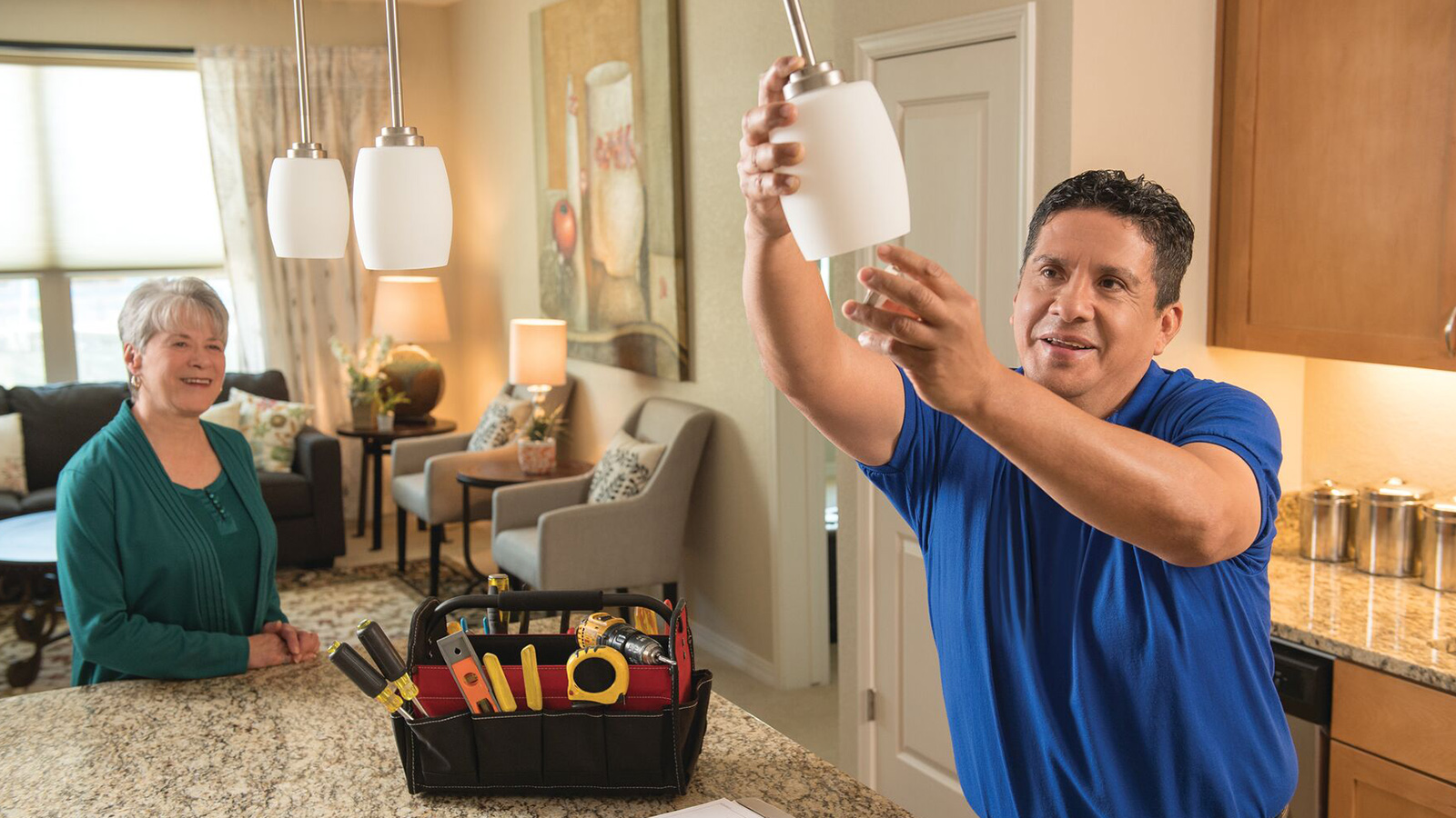 Erickson id the Right Choice Maintenance Professional helping tenant change bulb in residence