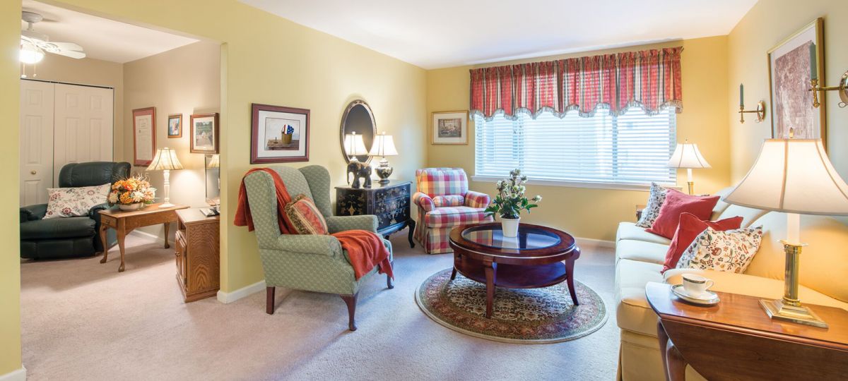 Image of a pleasant living area with large window and a view into a den.