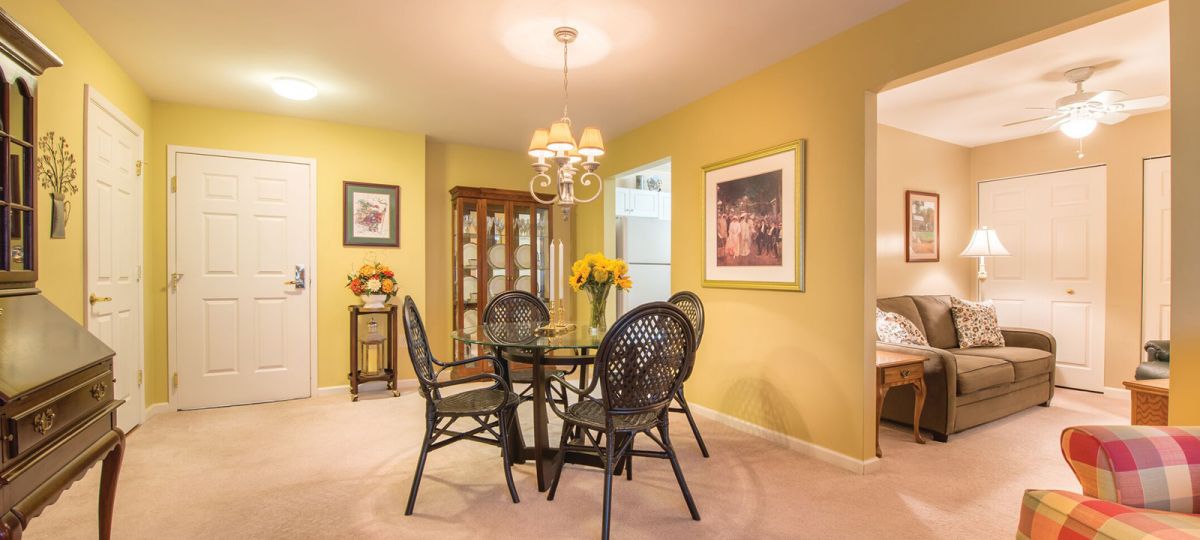 Image of a spacious living and dining area with a view into a den.