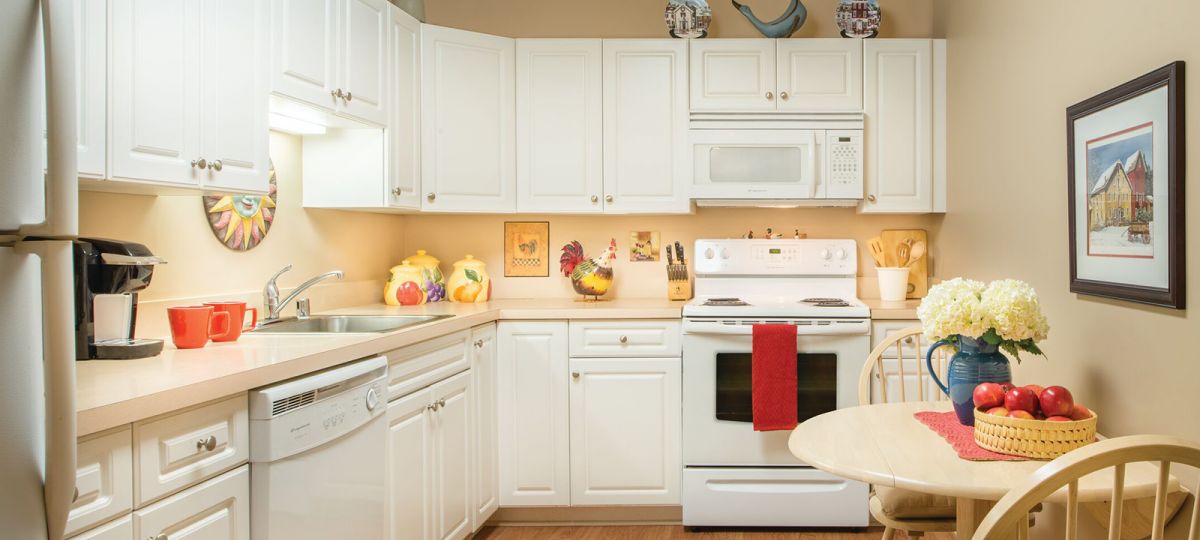 Image of a well lit, modern kitchen with room for a table.