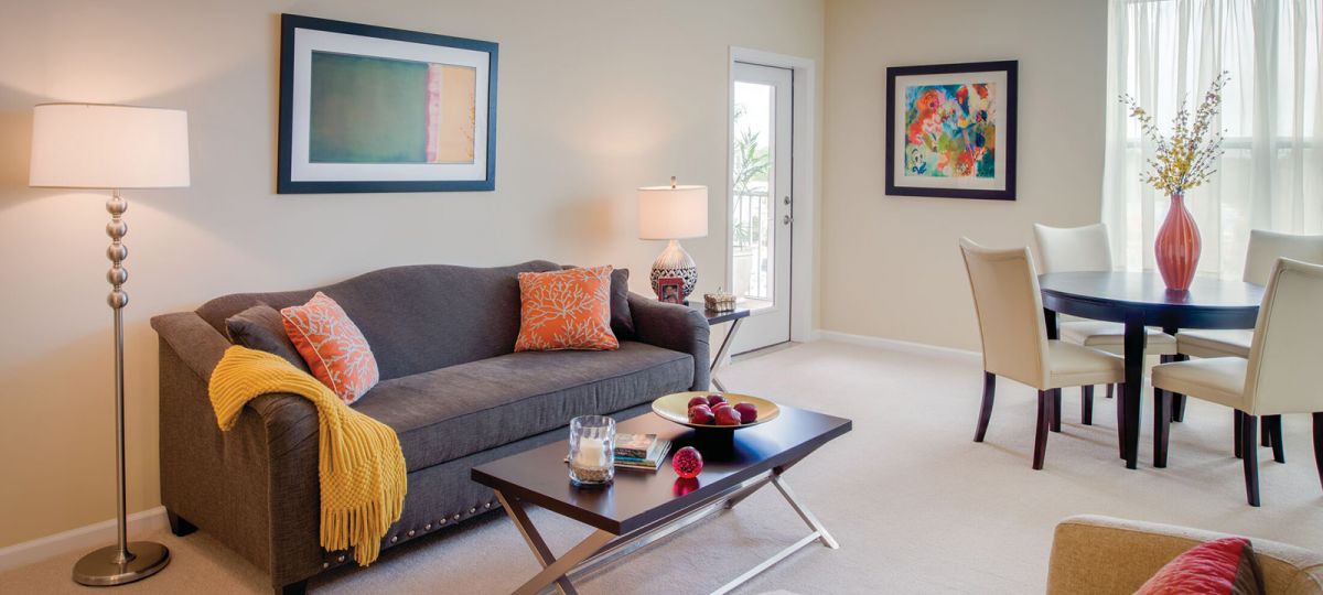 View of a roomy living and dining area with access to a balcomy.