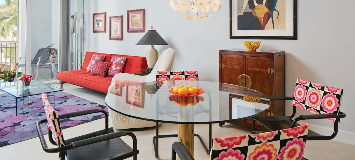 Room with round glass table and flowers