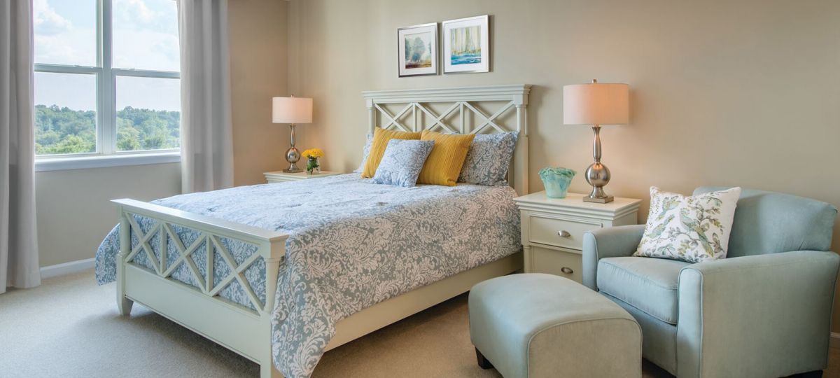 View of a bedroom with with large windows.