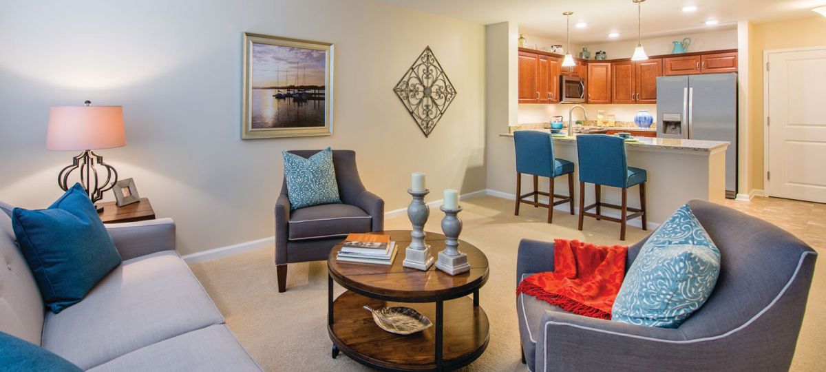 Open floor plan apartment with view of modern kitchen and living room.