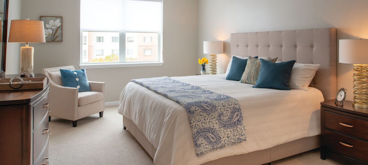Large bedroom with big window.