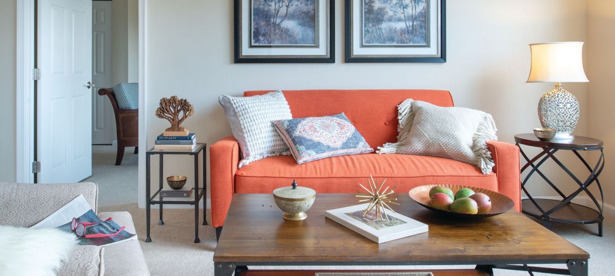 Large, open living room with view to the bedroom.