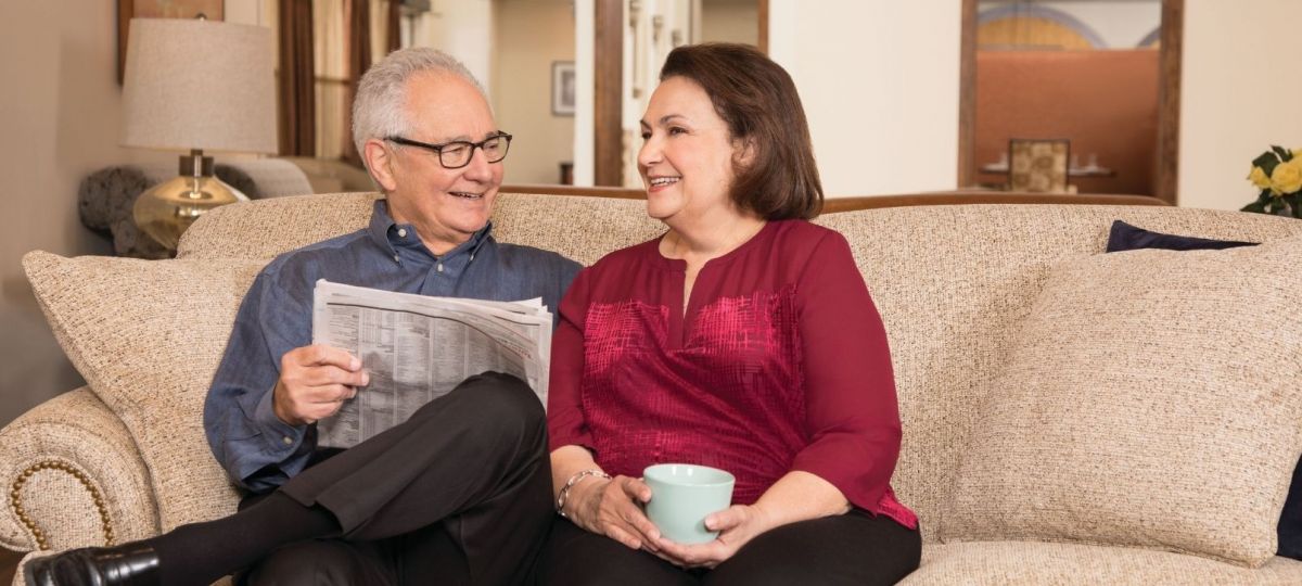 Two residents of Eagle's Trace seated in their stylish apartment home.