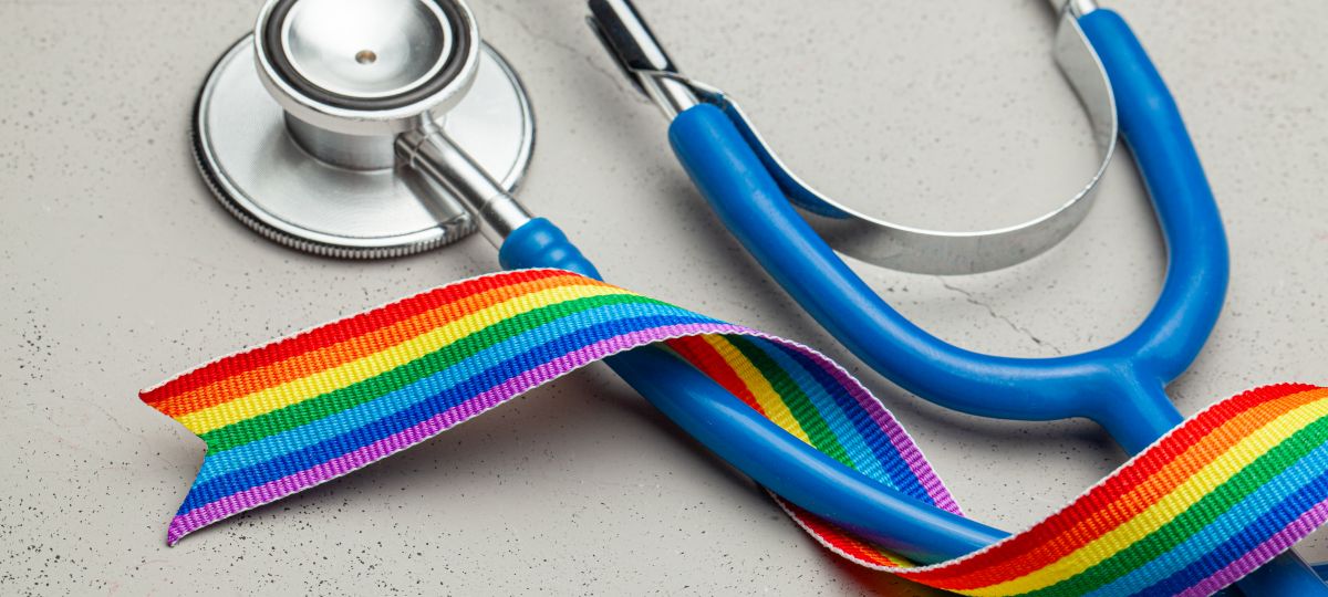 Photo features a stethoscope and a rainbow ribbon