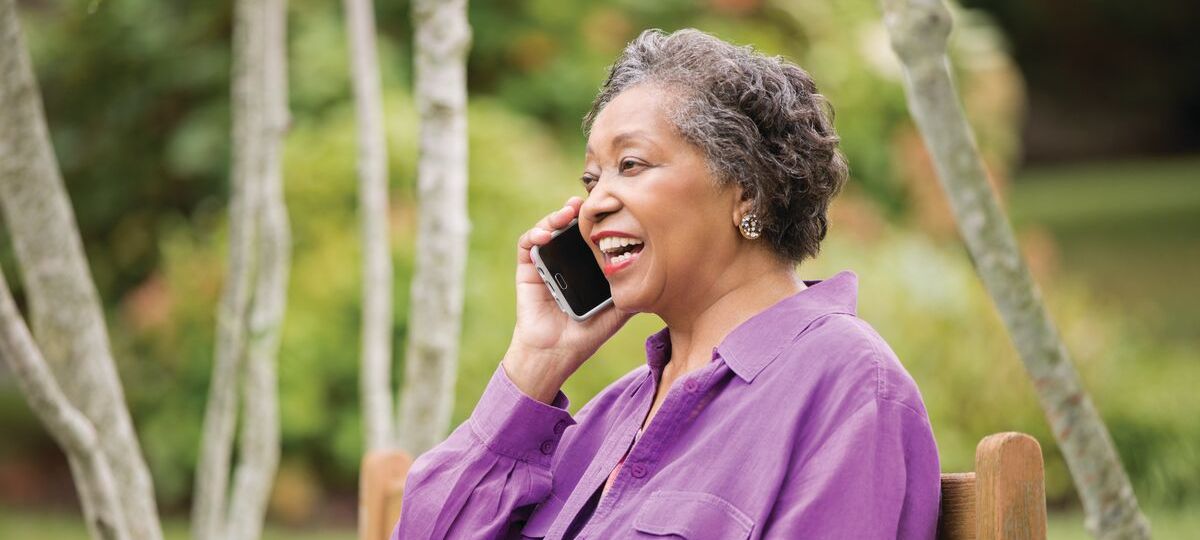 social_distance A woman speaks on her cell phone outdoors
