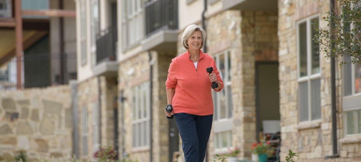 well-being Senior woman walks with weights