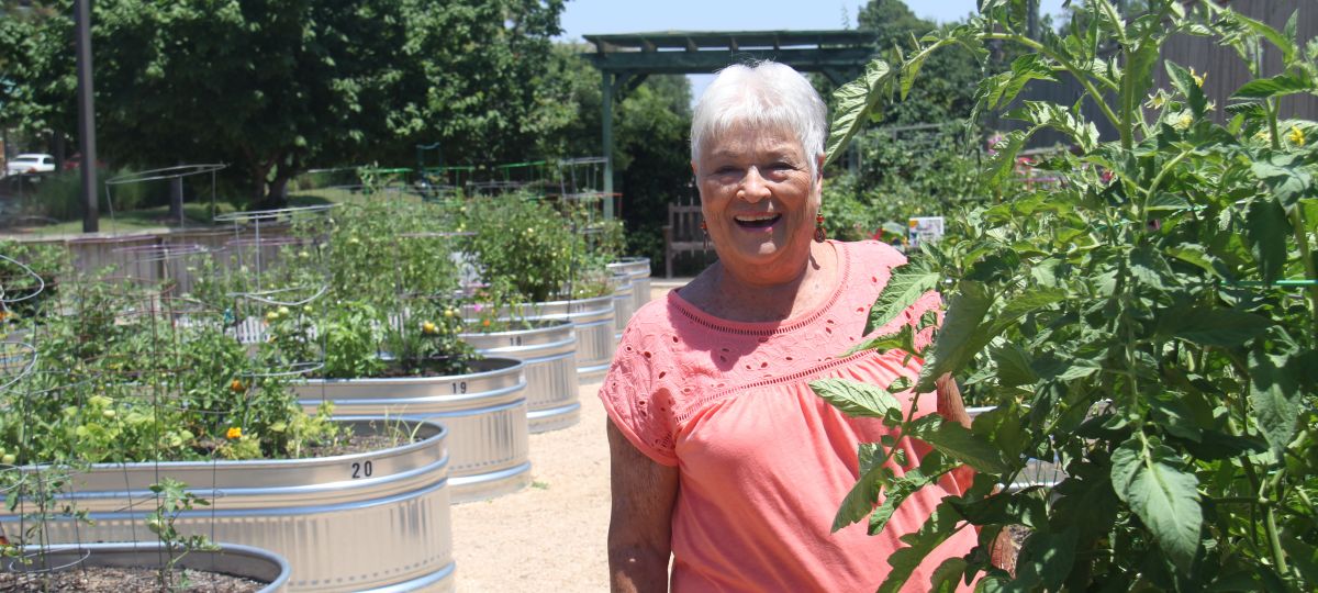 Eagle's Trace resident stands among the raised gardens