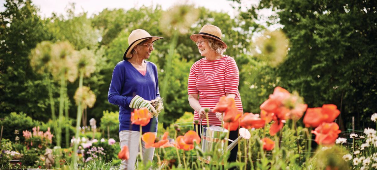 1610x906_Large-LPH_7_2018_2860_JL.jpg Two residents talking and laughing in the community garden.