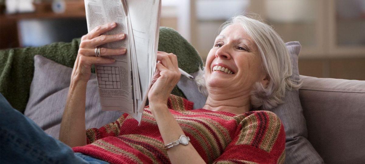 Woman relaxing with newspaper Woman relaxing