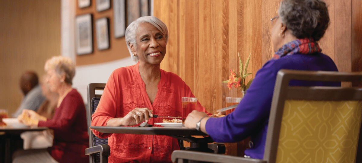 two women seated across from each other at a table