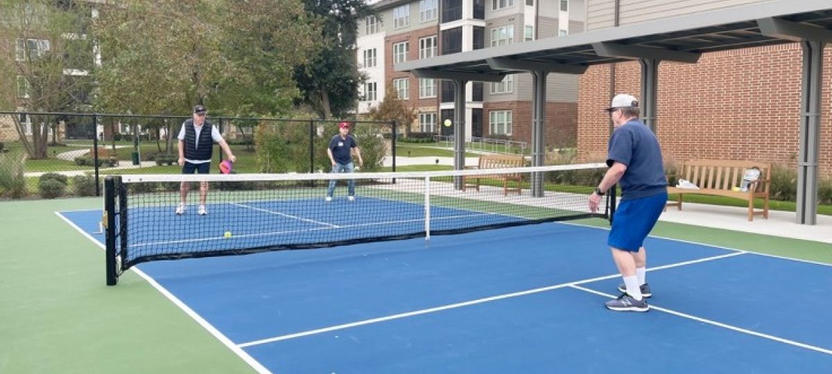 ETH Trib Local Feature-March 22 Residents at Eagle's Trace in West Houston enjoy playing pickleball on their outdoor court.