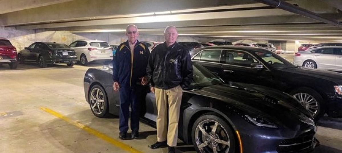Residents of Fox Run pose with their car in the underground parking garage.