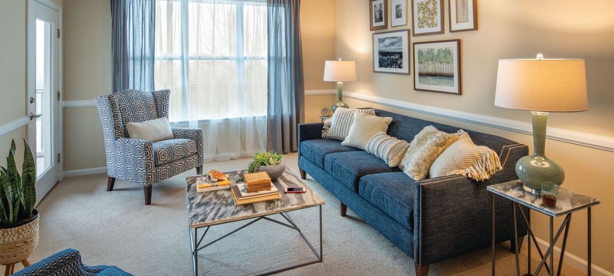 Interior shot of a nicely decorated, open living room in an Erickson two-bedroom apartment home.