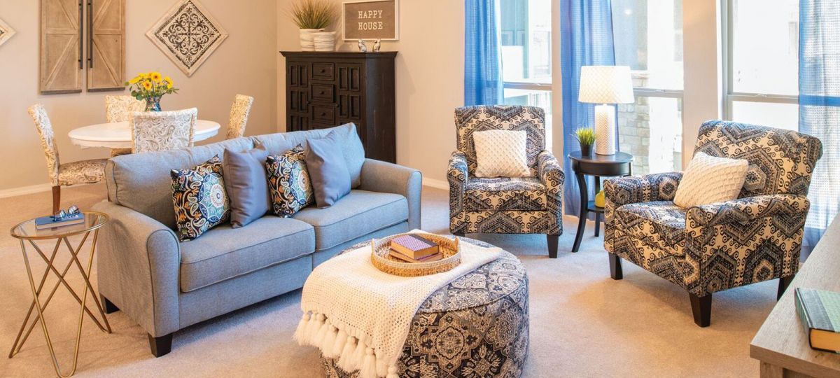 Interior shot of a nicely decorated, open living room in an Erickson two-bedroom apartment home.