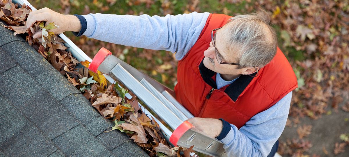 Man cleaning gutters Man cleaning gutters