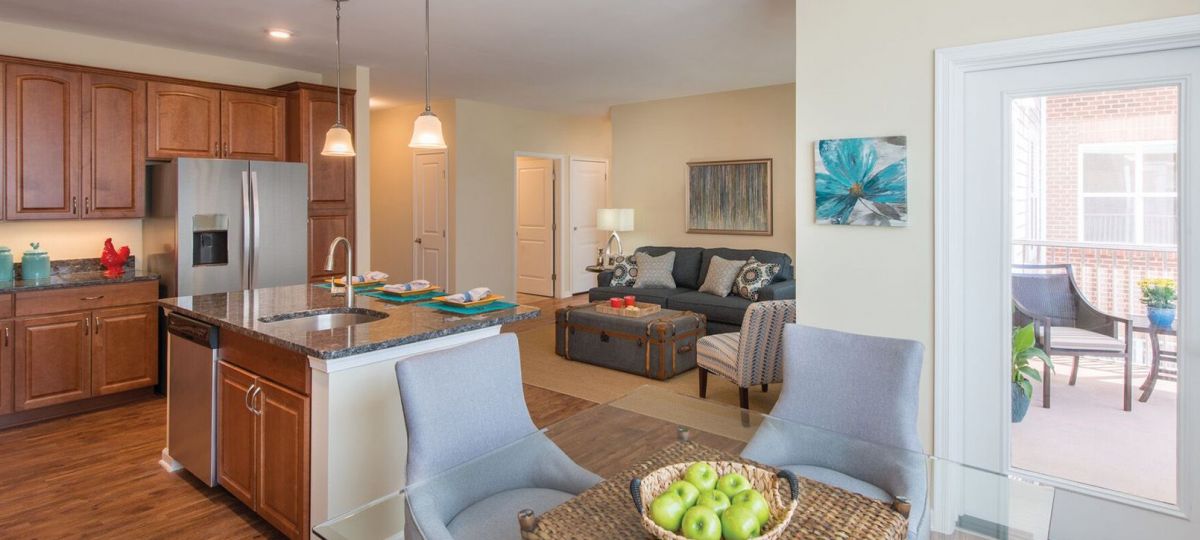 Wide shot of dining room and spacious, open living room.
