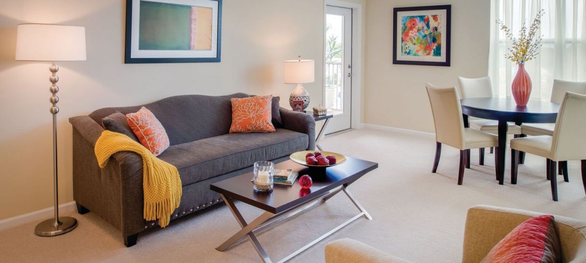 Interior shot of a nicely decorated, open living room in an Erickson two-bedroom apartment home.