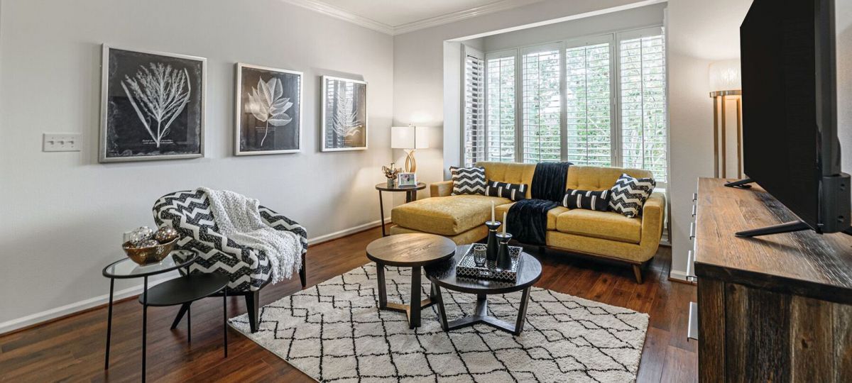 Interior shot of a nicely decorated, open living room in an Erickson two-bedroom apartment home.