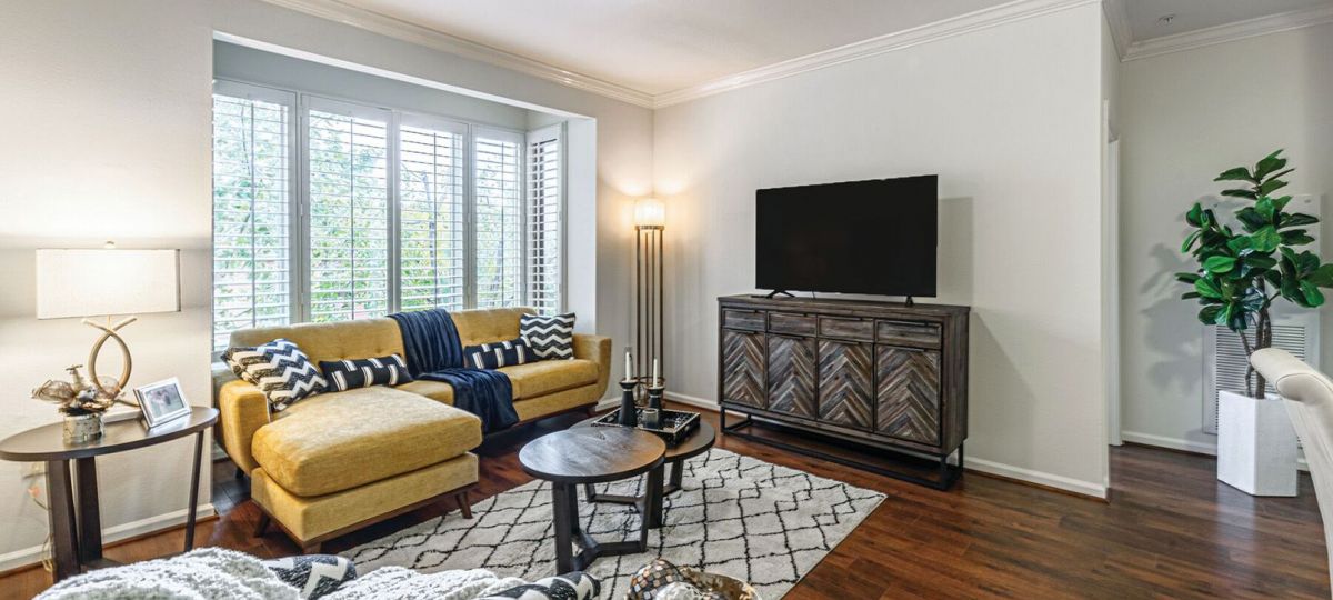 Interior shot of a nicely decorated, open living room in an Erickson two-bedroom apartment home.