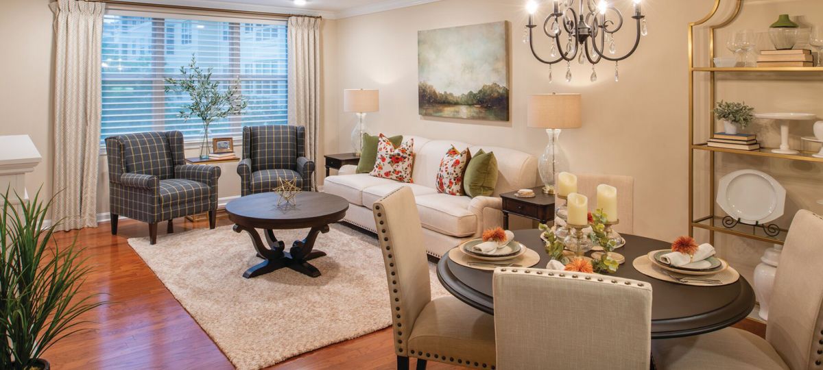 Interior shot of a nicely decorated, open living room in an Erickson two-bedroom apartment home.