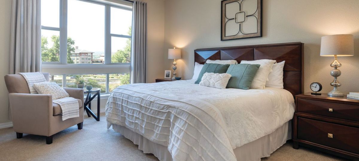 Wide shot of the bright, furnished main bedroom.