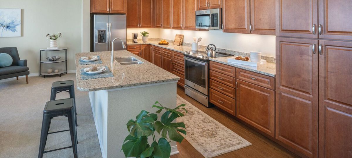 Interior shot of a bright kitchen and bar area in an Erickson one-bedroom apartment.