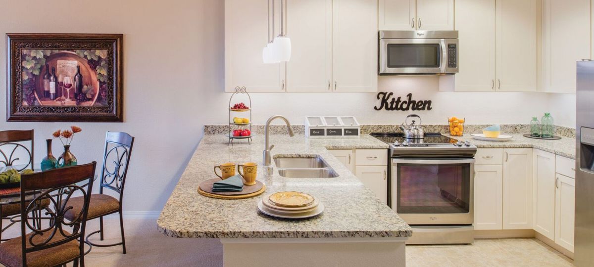 Wide shot of a spacious kitchen with breakfast bar.
