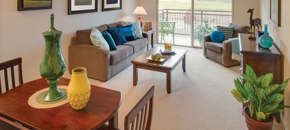Interior shot of a nicely decorated, open living room in an Erickson two-bedroom apartment home.