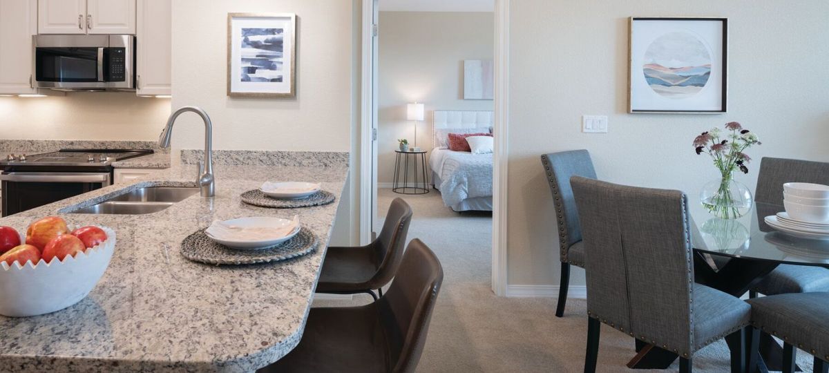 Interior shot of kitchen and breakfast bar inside of an Erickson two-bedroom apartment home.